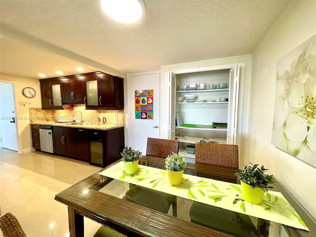 dining room with a textured ceiling, built in features, light tile patterned floors, and sink