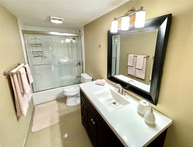 full bathroom with toilet, enclosed tub / shower combo, tile patterned floors, vanity, and a textured ceiling