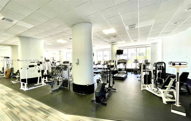 gym with a paneled ceiling