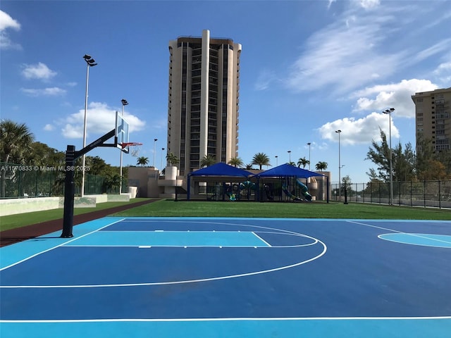 view of basketball court with a playground and a gazebo