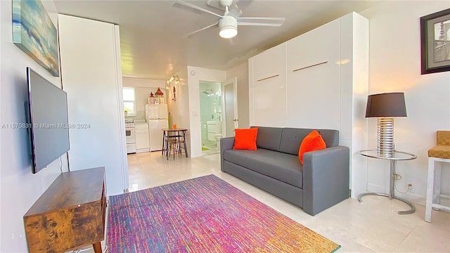 tiled living room with ceiling fan