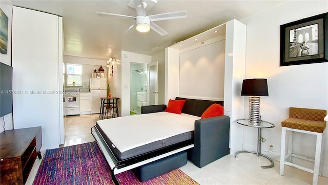 bedroom with white fridge, ceiling fan, and light tile floors