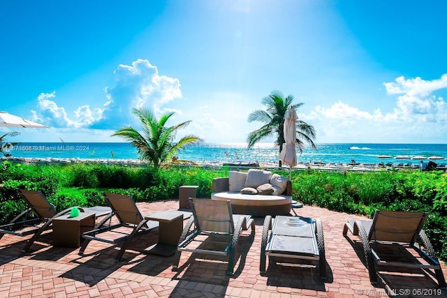 view of patio with a view of the beach and a water view