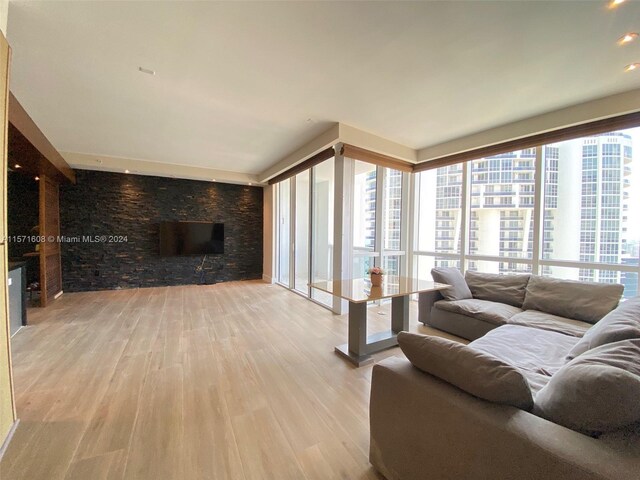 living room featuring light wood-type flooring and a healthy amount of sunlight