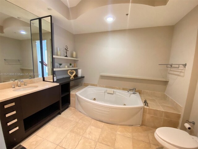 bathroom featuring a bathtub, vanity, and toilet