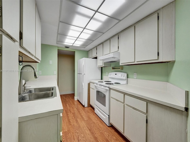 kitchen with sink, white appliances, and light hardwood / wood-style flooring