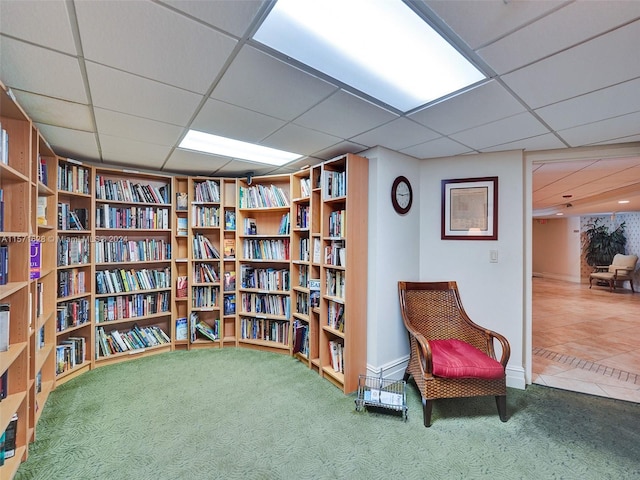 sitting room with carpet and a paneled ceiling