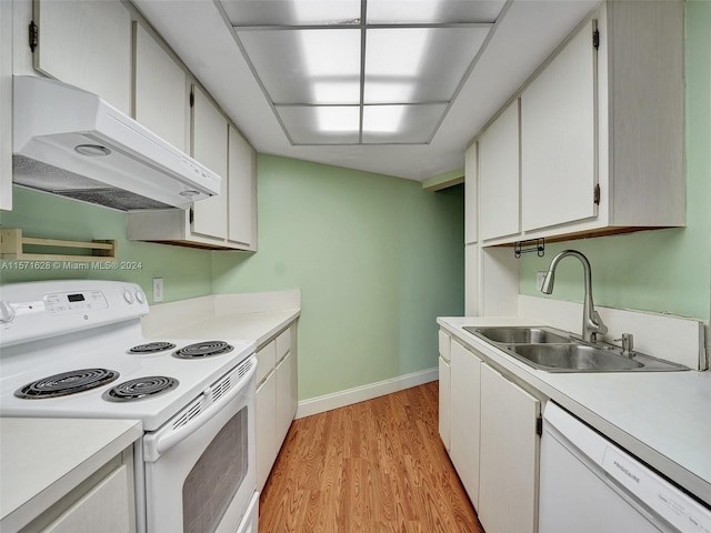 kitchen with sink, white appliances, premium range hood, and white cabinetry