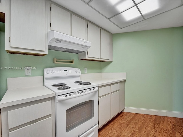 kitchen with white cabinets, light wood-type flooring, and white electric range