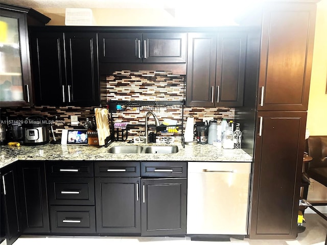 kitchen with sink, dishwasher, decorative backsplash, and light stone countertops