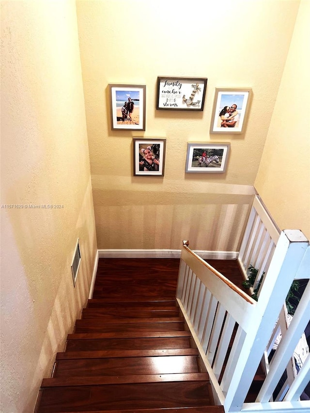 stairway featuring dark hardwood / wood-style floors