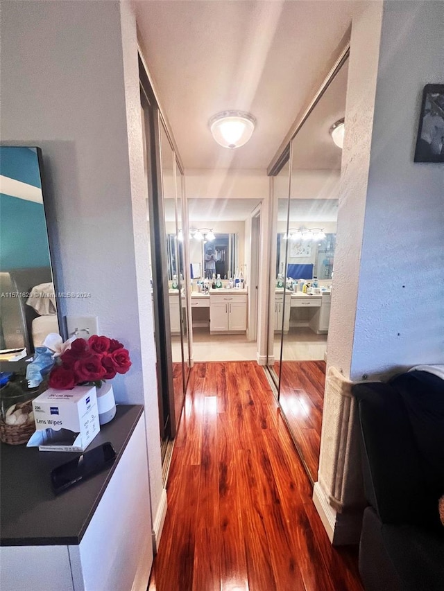 corridor with hardwood / wood-style floors