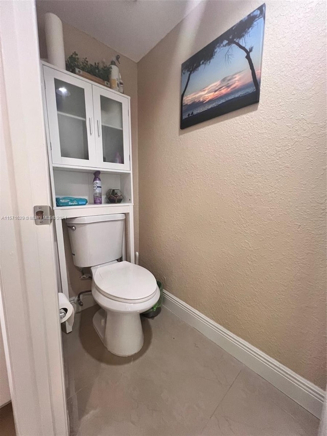 bathroom featuring tile patterned floors and toilet