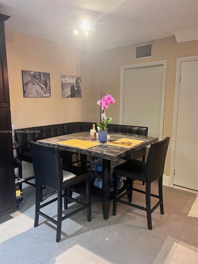 dining room with light tile patterned flooring