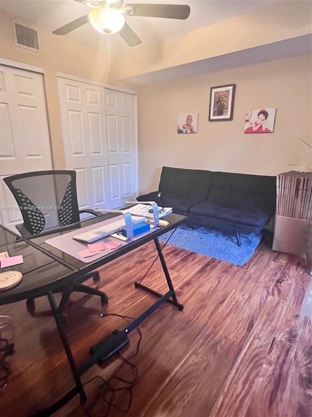 living room featuring ceiling fan and hardwood / wood-style flooring