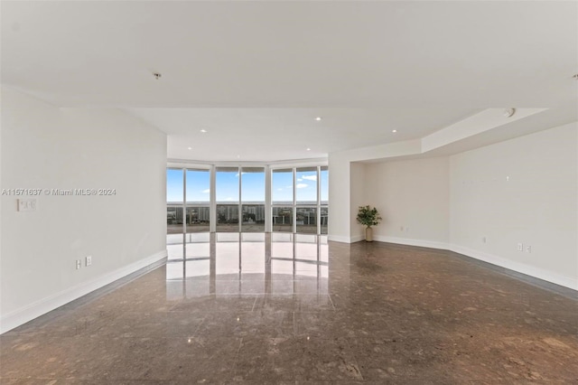 unfurnished room with expansive windows