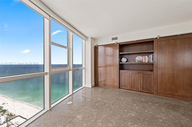 unfurnished room with a water view