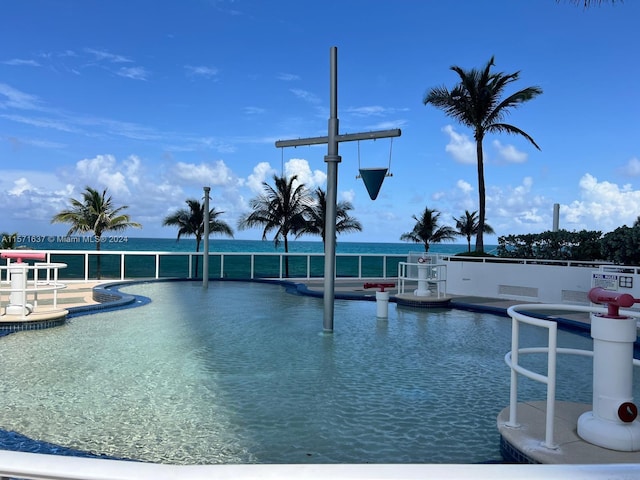 view of swimming pool featuring a water view