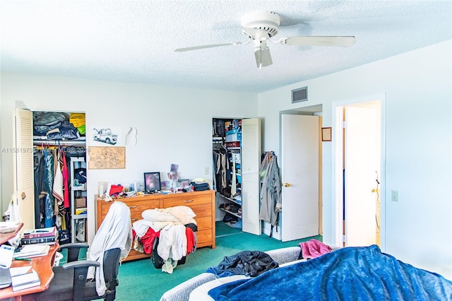 carpeted bedroom featuring a closet, a textured ceiling, and ceiling fan