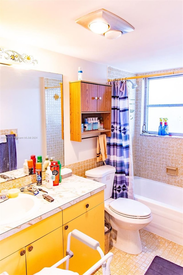 full bathroom with shower / bath combo with shower curtain, toilet, tile flooring, and vanity