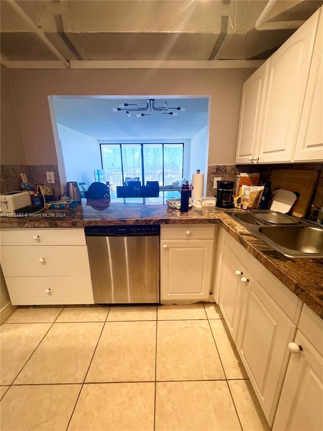 kitchen with light tile patterned flooring, dishwasher, sink, and white cabinets