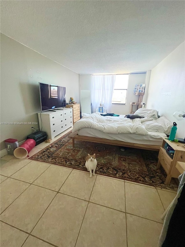 unfurnished bedroom featuring a textured ceiling and tile patterned floors