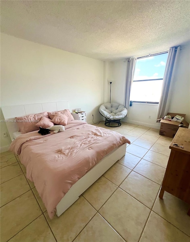 tiled bedroom with a textured ceiling