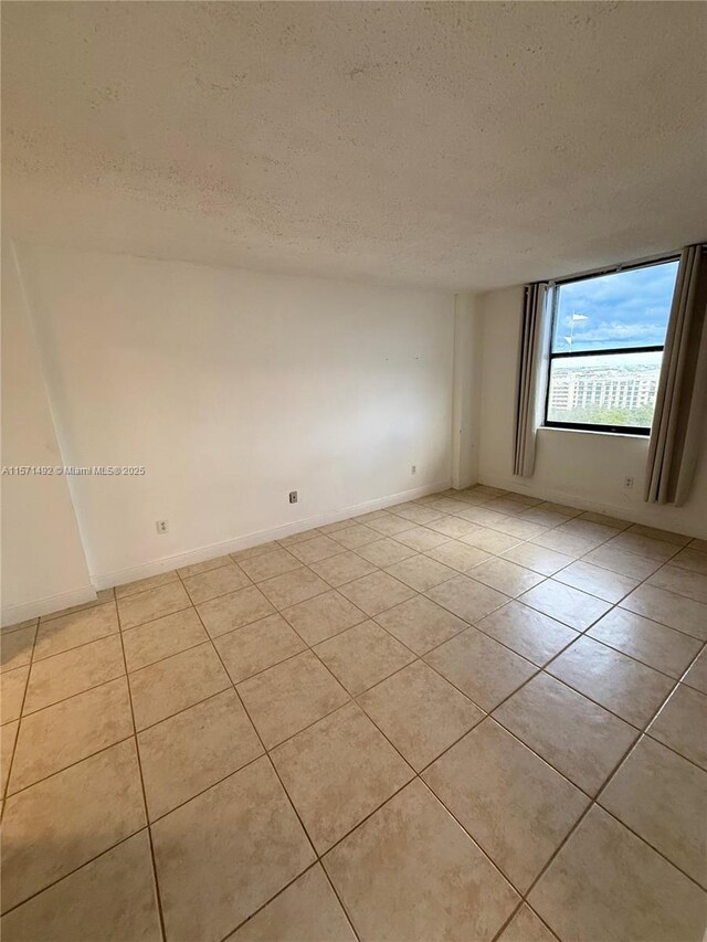 full bathroom with vanity, toilet, shower / bath combo with shower curtain, and tile patterned floors