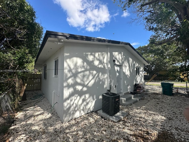 view of side of home with central AC