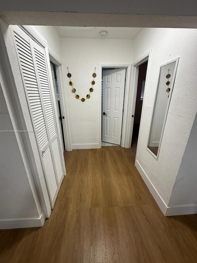 corridor featuring dark wood-type flooring