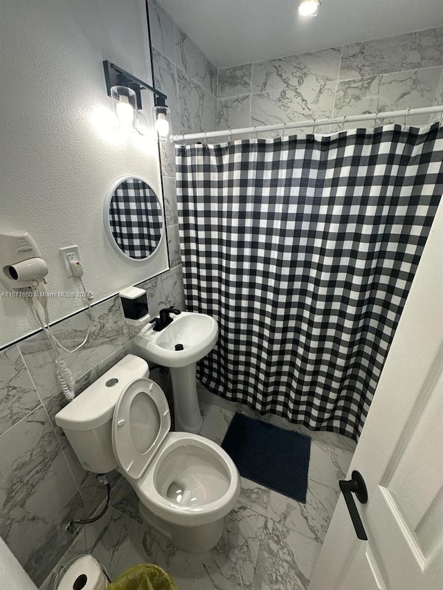 bathroom with sink, toilet, and tile flooring