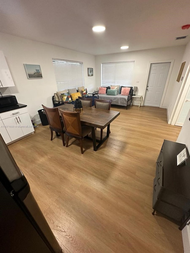 dining space with light hardwood / wood-style floors