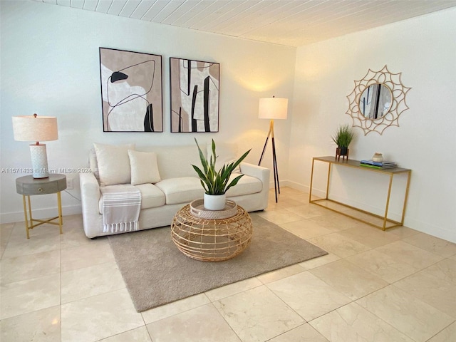 living room with wooden ceiling and tile patterned flooring