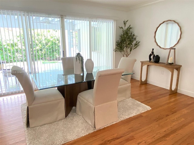 dining area featuring ornamental molding and hardwood / wood-style floors