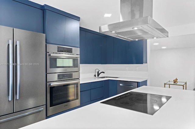 kitchen featuring sink, blue cabinets, island exhaust hood, and appliances with stainless steel finishes