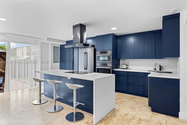 kitchen featuring a center island, sink, stainless steel appliances, blue cabinets, and extractor fan