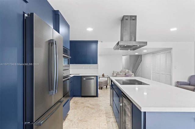 kitchen with blue cabinetry, beverage cooler, island exhaust hood, and appliances with stainless steel finishes