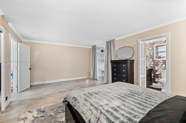 bedroom featuring ornamental molding, light hardwood / wood-style flooring, and ensuite bath