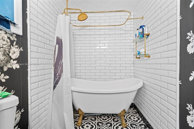 bathroom with tile patterned floors, shower / tub combo, and toilet