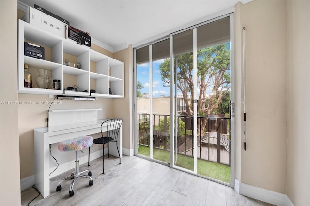 home office featuring light hardwood / wood-style floors and ornamental molding