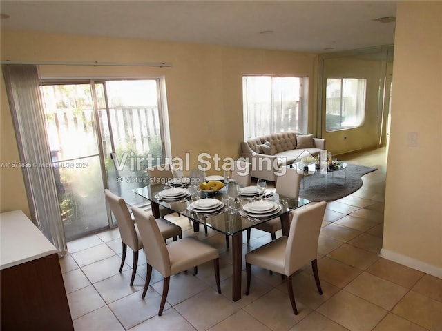 dining area with a wealth of natural light and light tile flooring