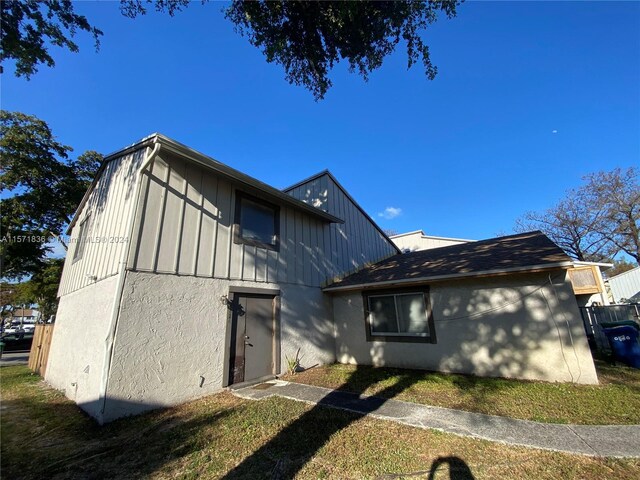 view of side of home featuring a lawn