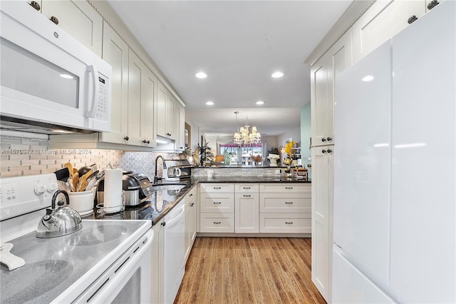 kitchen featuring white cabinetry, light hardwood / wood-style floors, white appliances, and decorative light fixtures