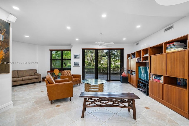 tiled living room featuring ceiling fan