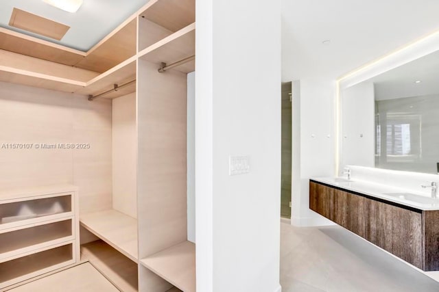 spacious closet featuring a sink