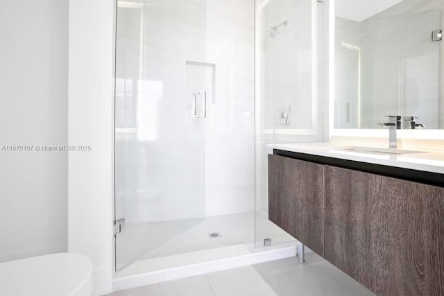 bathroom with toilet, a shower stall, and vanity