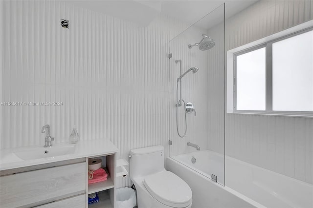 full bathroom with tiled shower / bath combo, vanity, and toilet