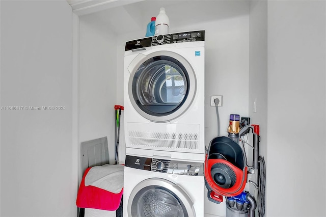 laundry room with stacked washer / dryer