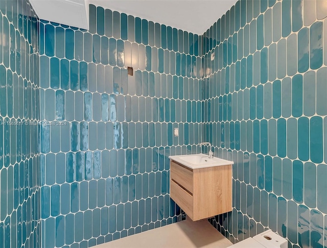 bathroom featuring tile walls and vanity