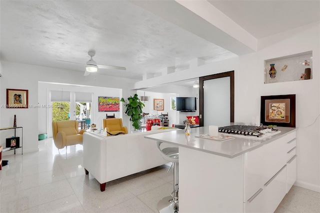 living room with ceiling fan and light tile floors